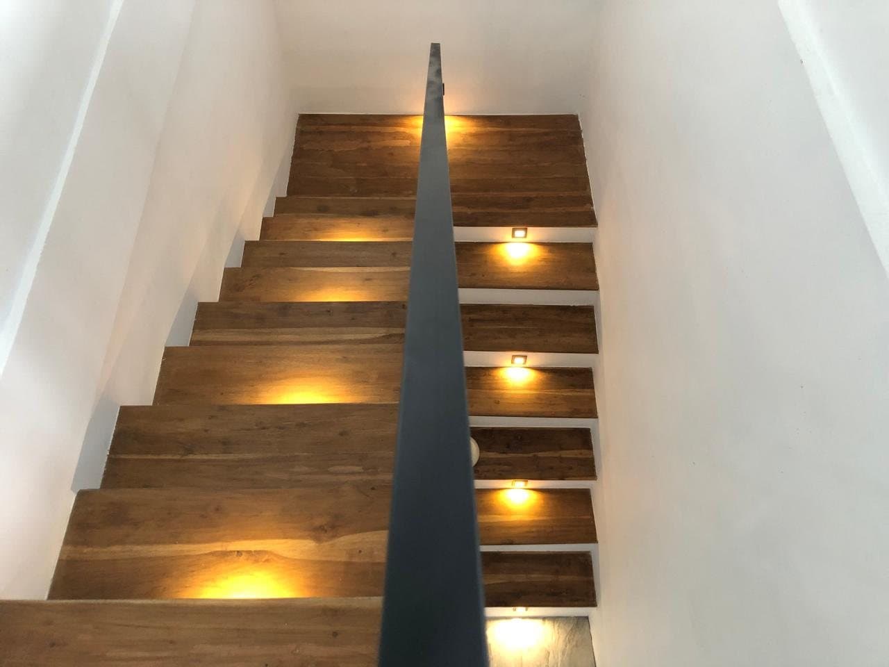 Wooden staircase lit by small step lights