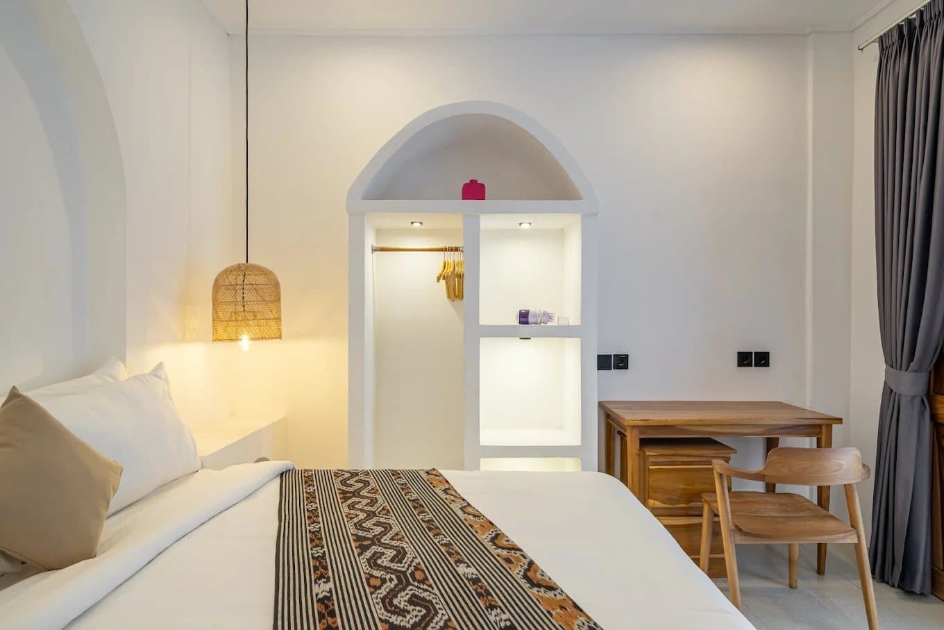 Bedroom with work desk and arched built-in wardrobe