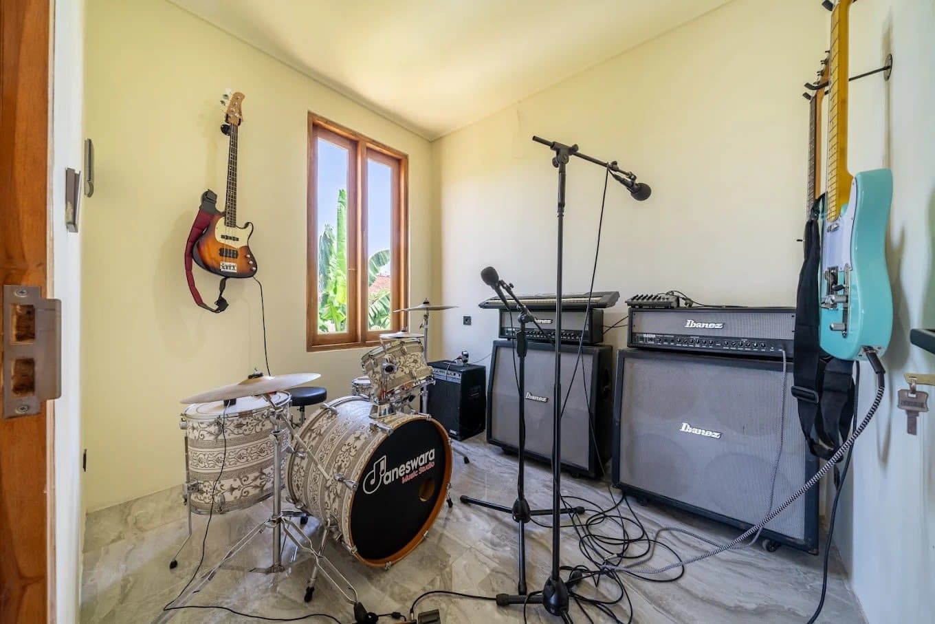 Music studio with drum kit, amplifiers and guitars