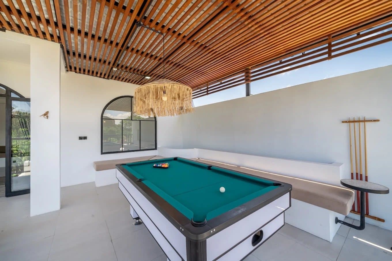 Covered upstairs deck with pool table and built-in seating